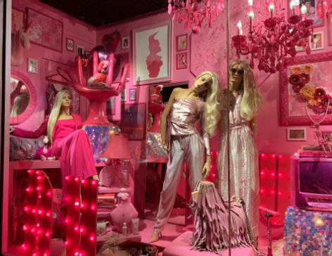 Unique pink display with mannequins and decorations.