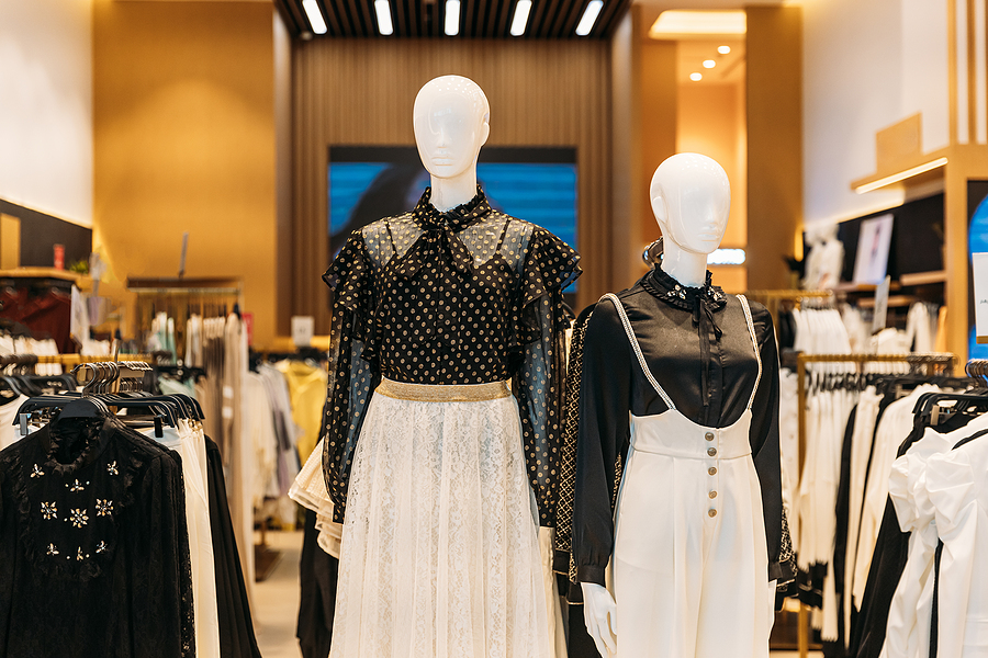 Two mannequin retail display wearing black and white outfits.