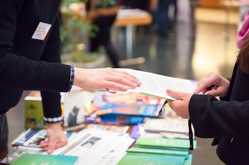 people talking at a trade show display 