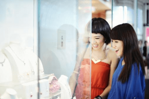 women looking at acrylic display case