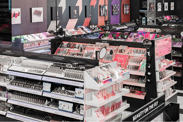 Makeup store display aisles with various beauty products.