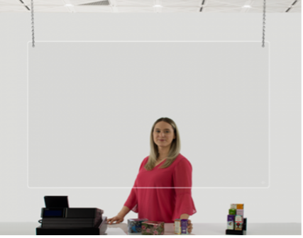 Woman standing behind plastic ceiling hanging sneeze guard