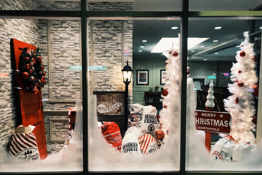 snowy store display with white christmas trees
