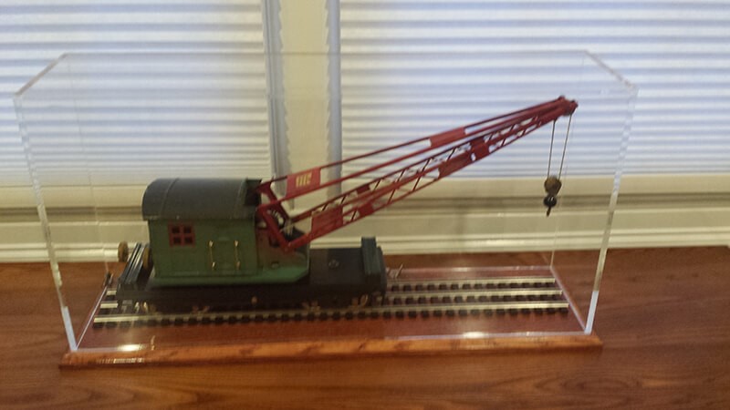 train with crane on tracks in acrylic display box with wooden base