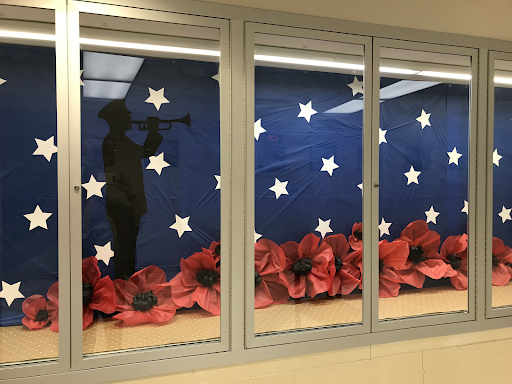 Memorial Day display of a storefront behind glass doors.