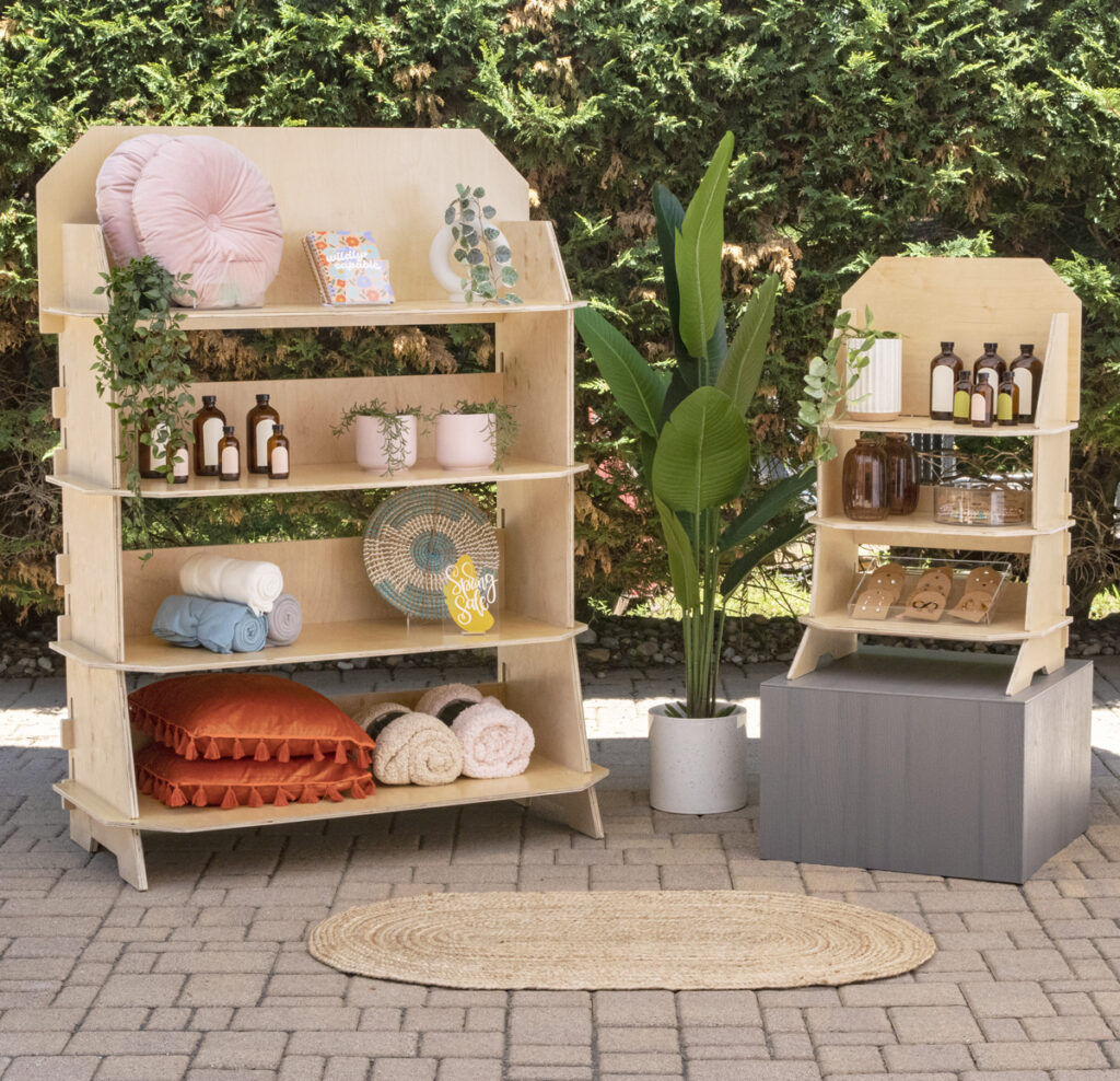 Two wooden portable and collapsible merchandiser displays in the outdoor under a tent at a craft fair