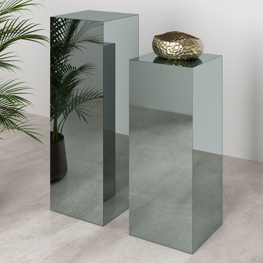 Two black mirrored pedestals.