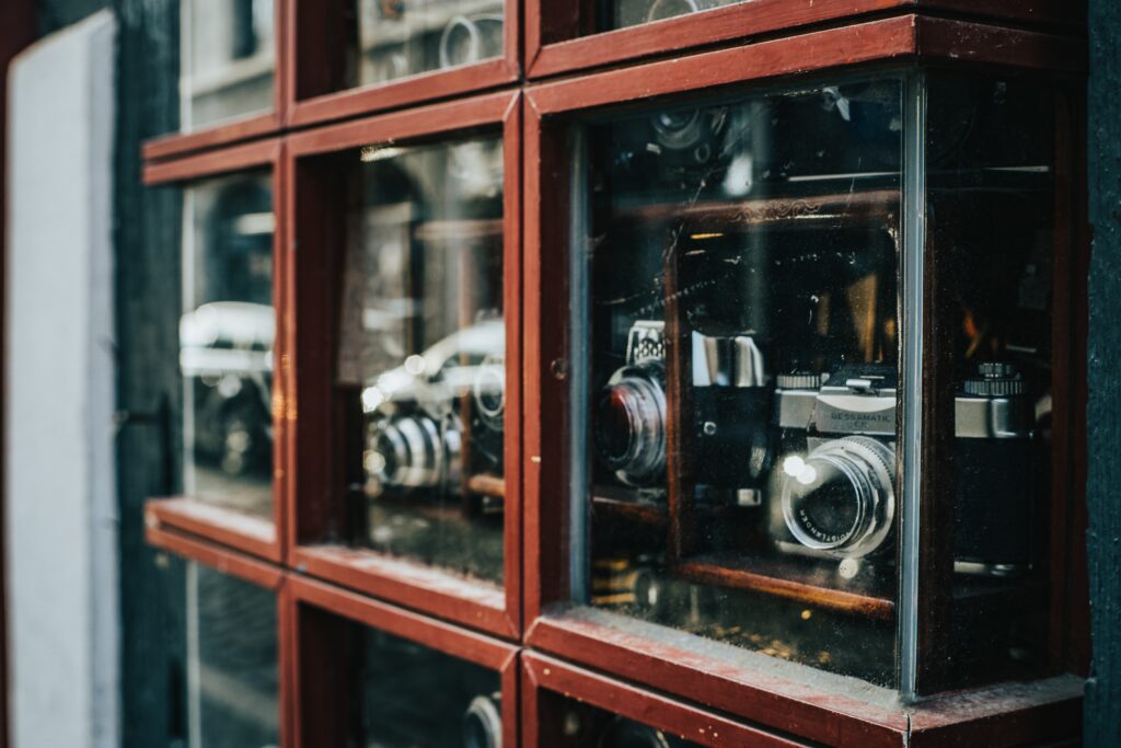 Assorted cameras in a display case