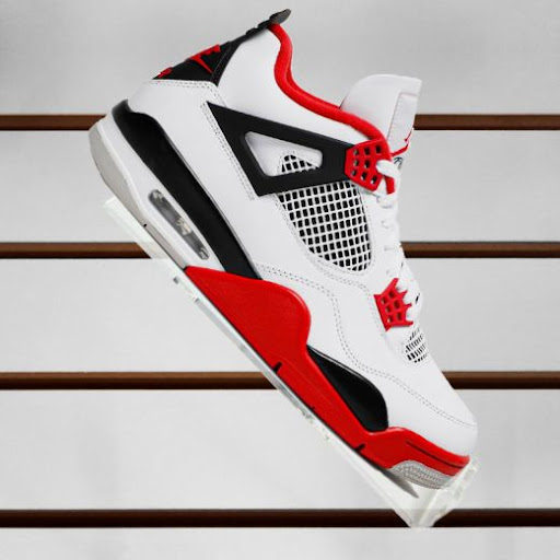 Black and red basketball sneaker on a acrylic slatwall shoe display