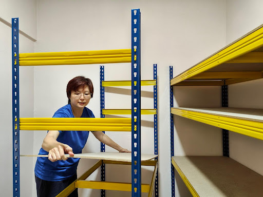 Woman installing wire rack shelving