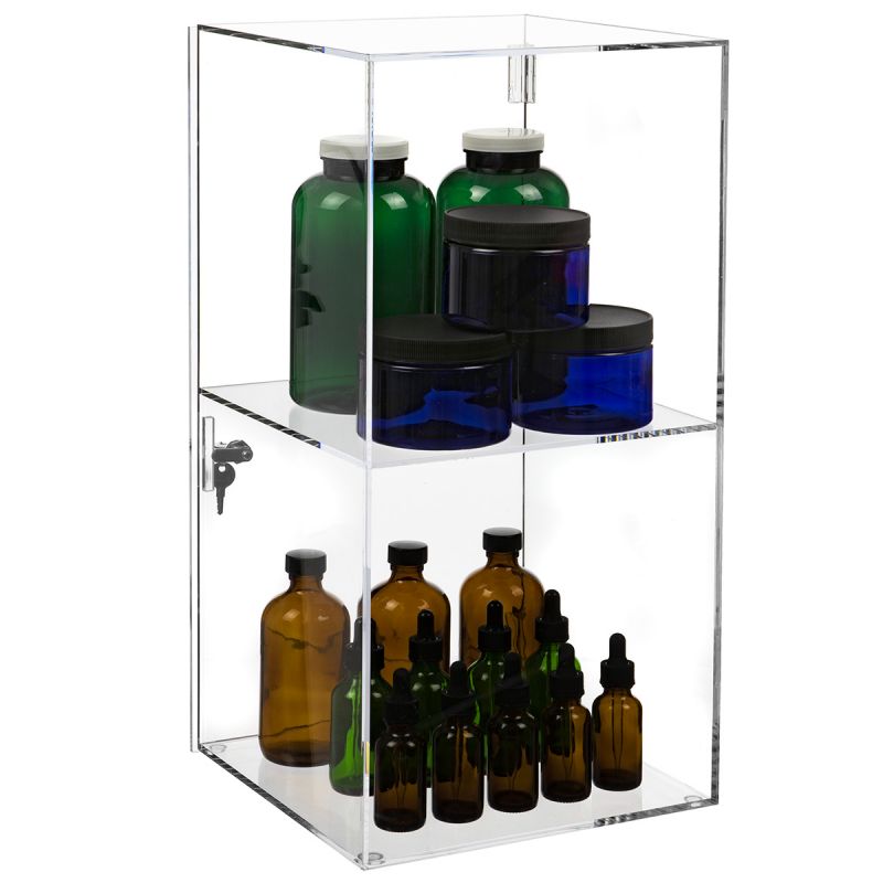 Clear acrylic display case showcasing empty bottles and small containers.
