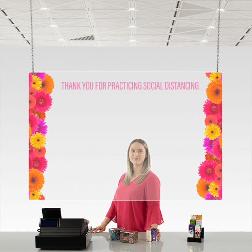 girl at checkout with custom acrylic ceiling sneeze guard